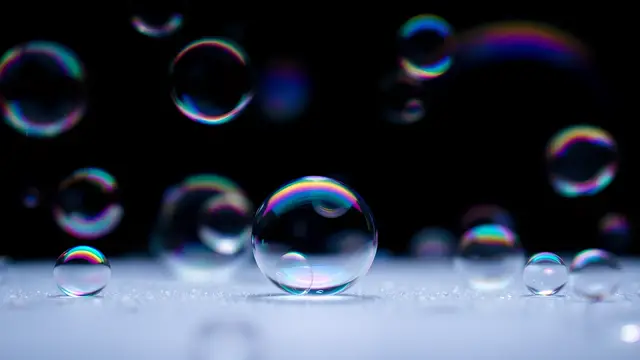 Soap bubbles with rainbow reflections, dark background