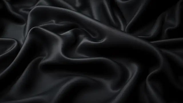 Folds of black silk catching soft highlights