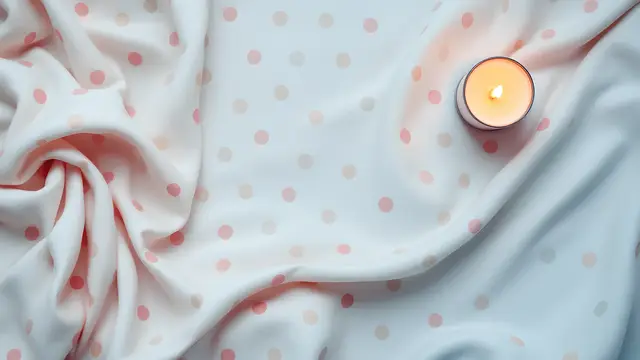 Pastel polka-dot fabric and a small round candle