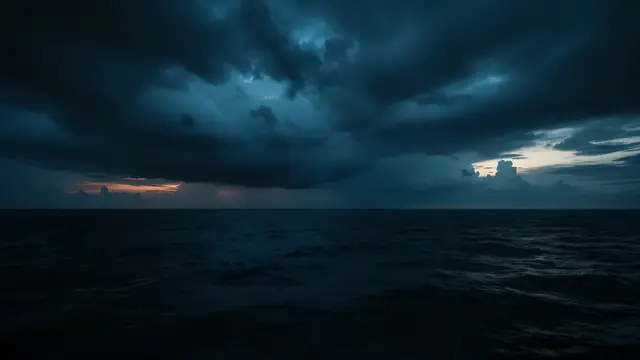 Dark storm clouds over a black sea at dusk