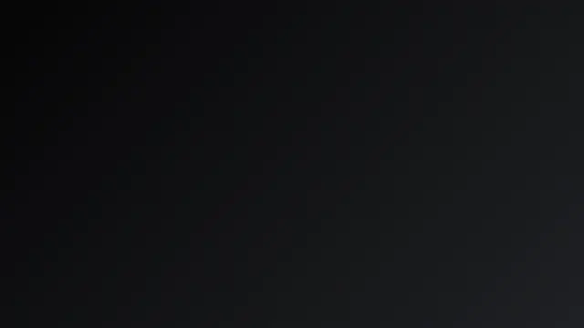 A smooth diagonal gradient from black to charcoal