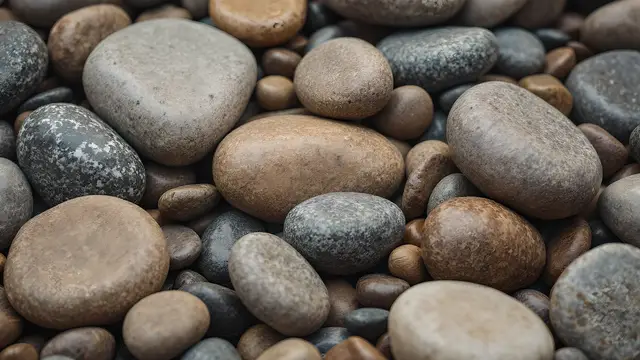 Smooth river stones layered together in muted earth tones
