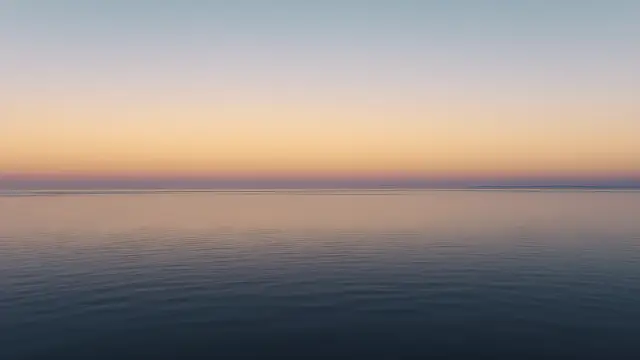 A calm ocean horizon at golden hour