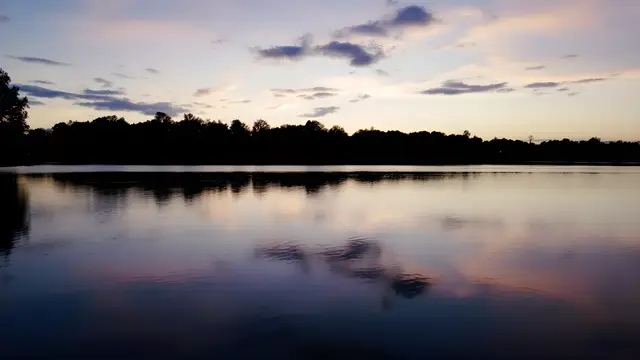 A calm lake reflecting an evening sky
