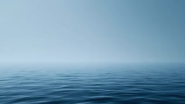 A calm water surface with a soft gradient horizon